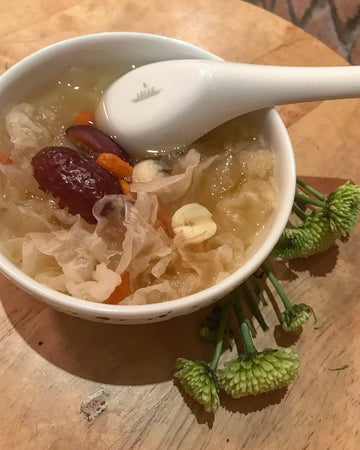 white fungus soup in bowl with red dates and lotus seed and goji berries