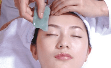 Guasha facial massage on chinese lady